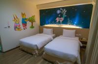 a room with two beds and a painting on the wall at Legend Hotel Kaohsiung Liuhe in Kaohsiung