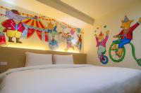 a bedroom with a bed and paintings on the wall at Legend Hotel Kaohsiung Liuhe in Kaohsiung