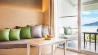 a living room with a couch with a bowl of fruit on a table at Amari Phuket in Patong Beach
