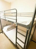 a couple of bunk beds in a room at Single inn- KAOHSIUNG LINSEN in Kaohsiung