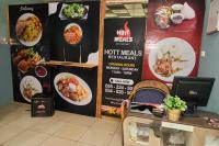 a restaurant with a menu of food on a wall at Legon City Mall Short Stay Apartments for Business and Vacation - East Legon in Accra