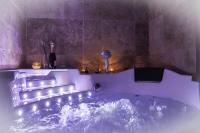 a purple bathroom with a tub with lights in it at Chez Aurélia - Chambres &amp; Table d&#39;hôtes in La Couture-Boussey