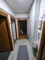 a hallway with a door and a motorcycle in a room at Apartman Danijela in Vukovar