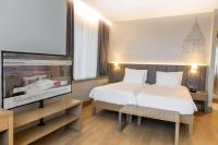 a hotel room with a bed and a flat screen tv at Radisson Hotel Istanbul Harbiye in Istanbul