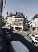 a city street with cars parked on the street at Haussemannien in Nevers