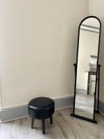 a black stool sitting next to a mirror at Haussemannien in Nevers