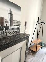 a living room with a picture of a clock tower at Haussemannien in Nevers