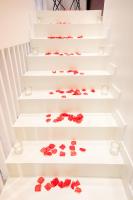 a set of white stairs with red roses on them at Luxury Collection &amp; Resort in Cormeilles-en-Parisis