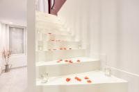 a white staircase with white shelves in a room at Luxury Collection &amp; Resort in Cormeilles-en-Parisis