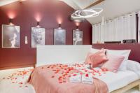 a bedroom with a bed with red flowers on it at Luxury Collection &amp; Resort in Cormeilles-en-Parisis