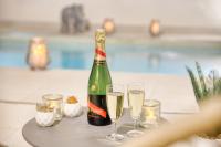 a bottle of champagne and two glasses on a table at Luxury Collection &amp; Resort in Cormeilles-en-Parisis