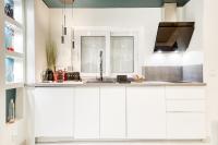 a kitchen with white cabinets and a sink at Luxury Collection &amp; Resort in Cormeilles-en-Parisis