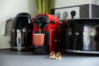 a red coffee maker sitting on a kitchen counter at Luxury Collection &amp; Resort in Cormeilles-en-Parisis