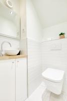 a white bathroom with a toilet and a sink at Luxury Collection &amp; Resort in Cormeilles-en-Parisis