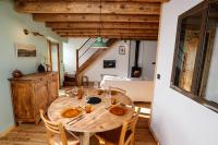 a dining room with a wooden table and chairs at Domaine Agricole Cotzé &#47; Casa rural in Enveitg