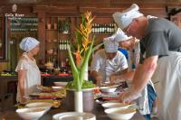 a group of chefs preparing food in a kitchen at Hoi An Coco River Resort & Spa in Hoi An
