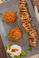 a plate of food with fried rice and meat at Hotel Neckarblick in Bad Wimpfen