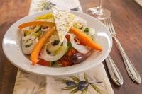 a white plate of food with vegetables on a table at Hotel Neckarblick in Bad Wimpfen