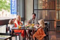 a family sitting at a table in a restaurant at Hyatt Regency Brisbane in Brisbane