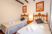 Postel nebo postele na pokoji v ubytování El Chorro Villas Casa Adelfa
