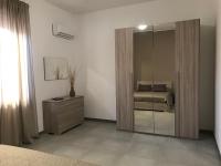 A bed or beds in a room at Scogliera apartments