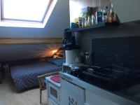 a kitchen with a sink and a bed in a room at Studio centre-ville climatisé avec parking gratuit in Clermont-Ferrand