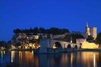 a bridge over a river with a city at night at Duplex district Saint Ruf near ramparts Avignon center in Avignon