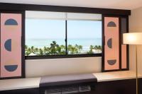 a room with a window with a view of the ocean at Hotel Renew in Honolulu