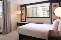a hotel room with a bed and a window at Hotel Renew in Honolulu