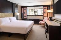 a hotel room with a bed and a desk at Hotel Renew in Honolulu
