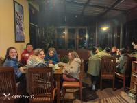 a group of people sitting at a table in a restaurant at Yoga House in McLeod Ganj
