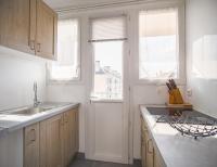 a kitchen with white cabinets and a sink and two windows at Le May Flower - 3 Chambres - Proche Centre-Ville in Troyes