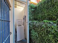 an open door to a garden with a hedge at Le PETIT BALCON by Booking Guys in Nice