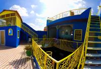 a blue and yellow building with a yellow staircase at Hotel Medina in Marrakech