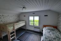 a bedroom with two bunk beds and a window at La Cabane aux Acacias~vacances nature et au calme in Mézos