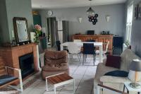 a living room with a couch and a table at La Cabane aux Acacias~vacances nature et au calme in Mézos