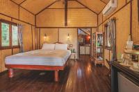 a bedroom with a bed in a room at Banyan Bay Villas in Ko Jum