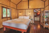 a bedroom with a large bed in a room at Banyan Bay Villas in Ko Jum