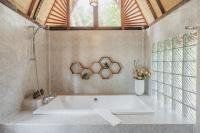 a large bath tub in a bathroom with a window at Banyan Bay Villas in Ko Jum