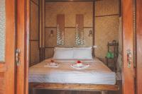 a bedroom with a bed with two dolls on it at Banyan Bay Villas in Ko Jum