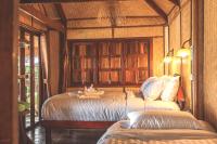 a bedroom with two beds in a room with wooden walls at Banyan Bay Villas in Ko Jum