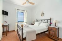 A bed or beds in a room at Reggina's Apartments