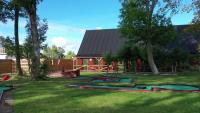a yard with green grass and trees and a house at GEG Hotel in Landskrona