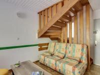 a living room with a couch and a staircase at Appartement Luz-Saint-Sauveur, 3 pièces, 6 personnes - FR-1-402-44 in Luz-Saint-Sauveur