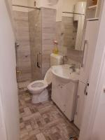a small bathroom with a toilet and a sink at Kineski zid in Zenica