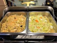 two metal trays of food in an oven at Link World Hotel in Taipei