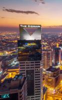 Un edificio alto con un cartel encima. en The Domain Bahrain Hotel and Spa - Adults Friendly 16 Years Plus, en Manama