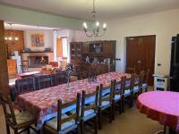 a dining room with a long table and chairs at B&B Rox e Claudia in Lugnola