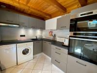 a kitchen with a washing machine and a washer at Appartement Le Grand-Bornand, 3 pièces, 6 personnes - FR-1-241-61 in Le Grand-Bornand