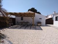 a patio with a table and chairs in front of a building at Maison Noirmoutier-en-l&#39;Île, 4 pièces, 6 personnes - FR-1-224B-646 in Noirmoutier-en-l&#39;lle